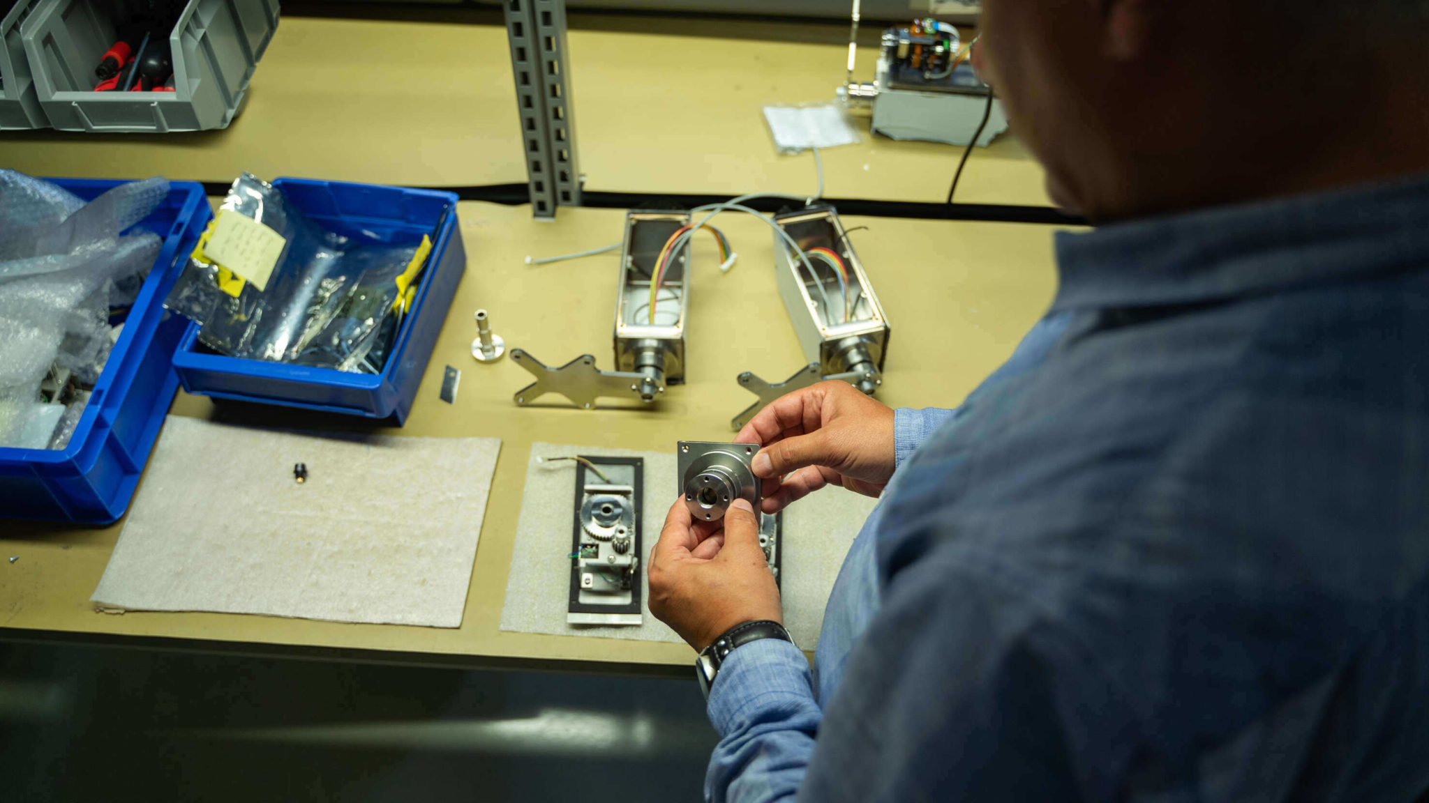 Engineer performing technical work on radiation-tolerant cameras at ISEC